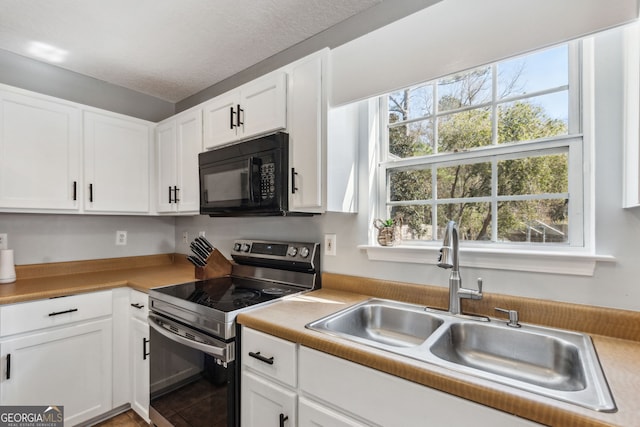 kitchen with sink, electric range, a textured ceiling, and white cabinets