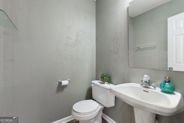 bathroom with toilet and sink