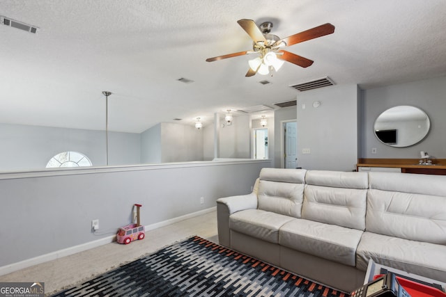 living room with light carpet, ceiling fan, sink, and a textured ceiling