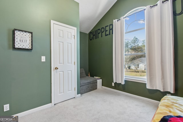 carpeted bedroom with vaulted ceiling