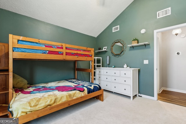 carpeted bedroom with lofted ceiling