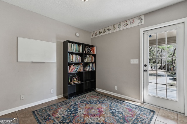 interior space featuring tile patterned floors and a textured ceiling