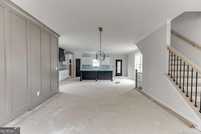 interior space with crown molding and baseboards