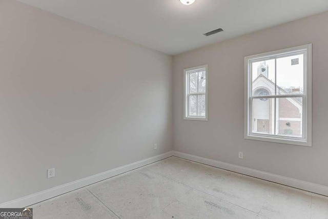 spare room featuring baseboards and visible vents