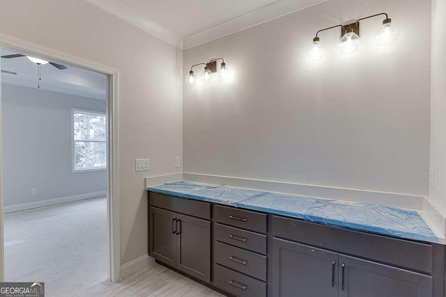 bathroom featuring crown molding and baseboards