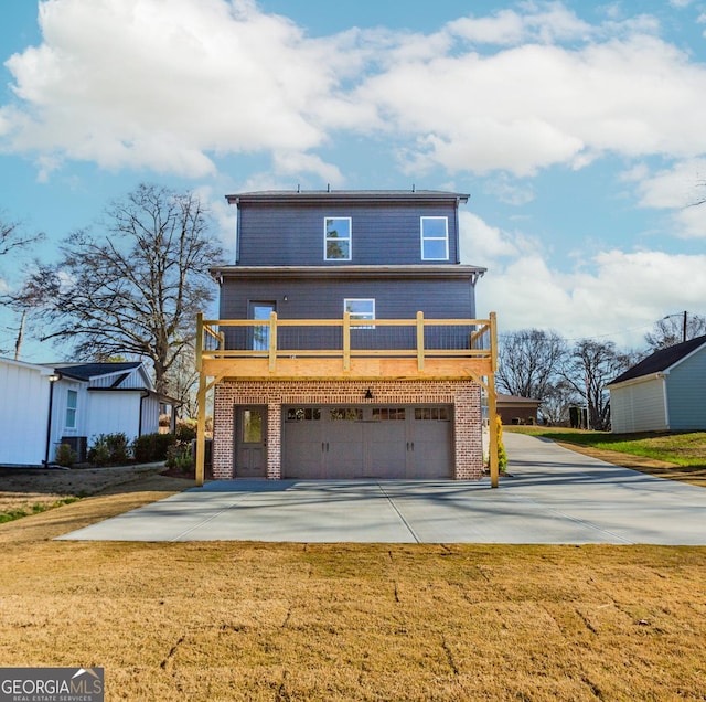 view of front of house featuring a garage, brick siding, concrete driveway, and a front lawn