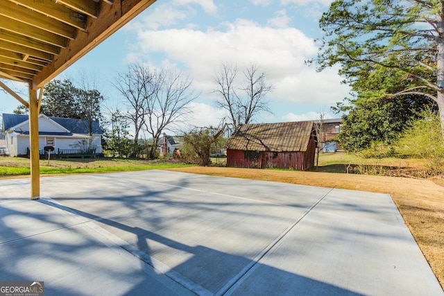 view of patio featuring an outbuilding