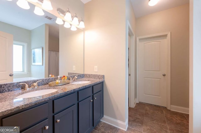 bathroom with tile patterned flooring and vanity