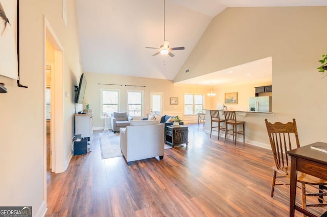 living room featuring ceiling fan, dark hardwood / wood-style floors, and high vaulted ceiling