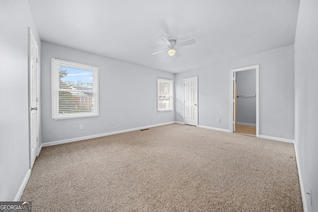 unfurnished bedroom featuring ceiling fan and carpet floors