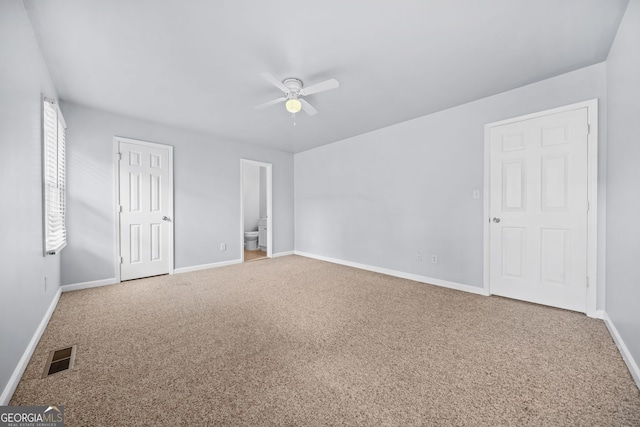 unfurnished bedroom with connected bathroom, ceiling fan, and carpet flooring