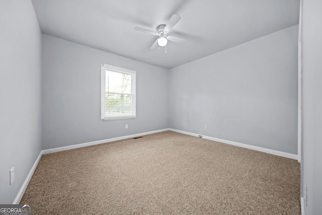 carpeted empty room with ceiling fan