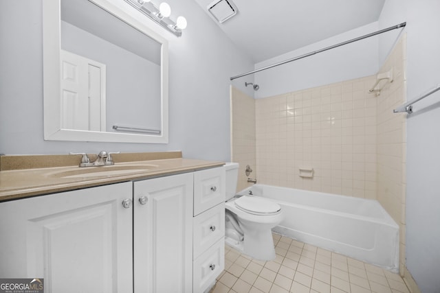 full bathroom featuring tiled shower / bath combo, vanity, tile patterned floors, and toilet