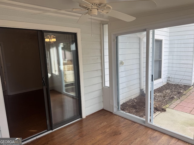 unfurnished sunroom featuring ceiling fan