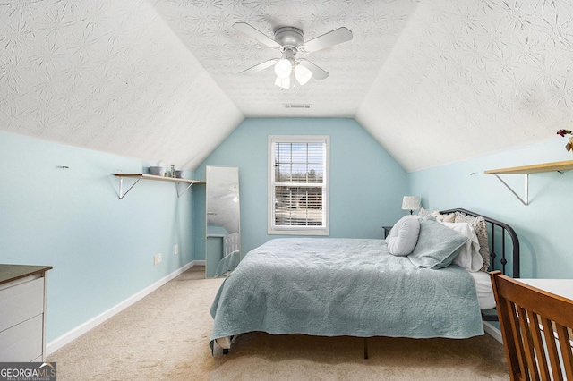 carpeted bedroom with lofted ceiling, ceiling fan, a textured ceiling, visible vents, and baseboards