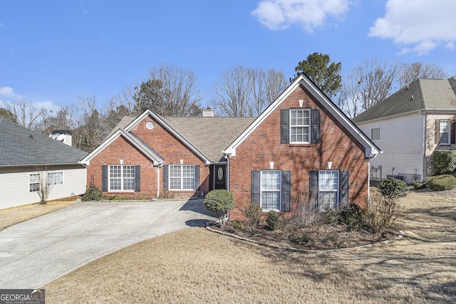 traditional-style home featuring brick siding and a chimney