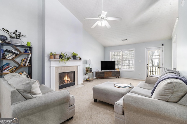 living area with light carpet, a fireplace, visible vents, and a textured ceiling