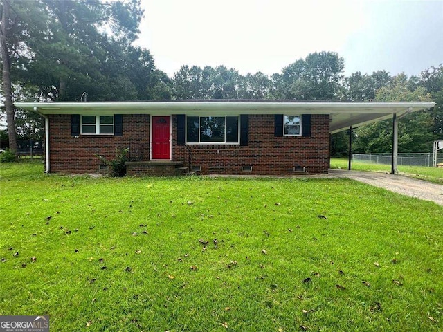 view of front of home with a front yard and a carport