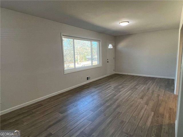 empty room with dark hardwood / wood-style floors