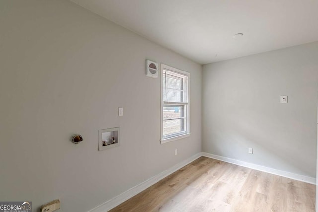 clothes washing area with hookup for a washing machine and light hardwood / wood-style floors