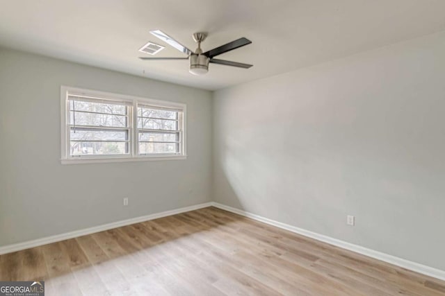 empty room with ceiling fan and light hardwood / wood-style flooring