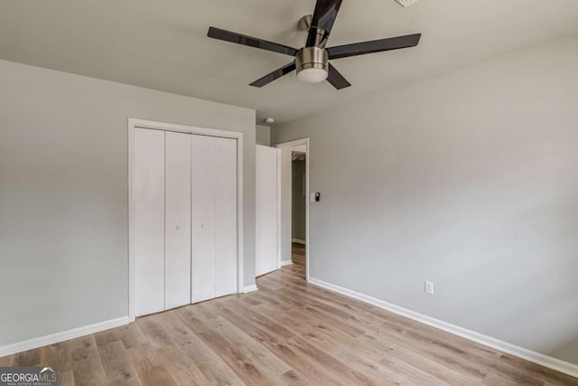 unfurnished bedroom featuring ceiling fan, light hardwood / wood-style floors, and a closet