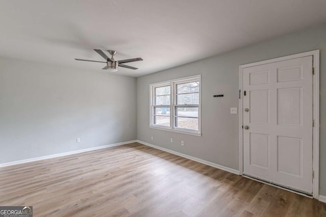 foyer entrance with ceiling fan and light hardwood / wood-style floors