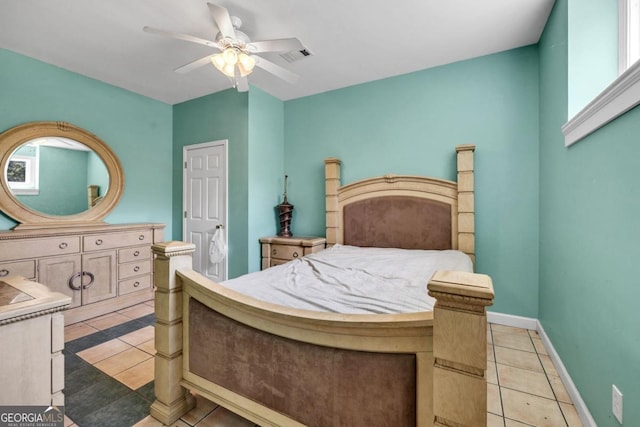 tiled bedroom featuring ceiling fan