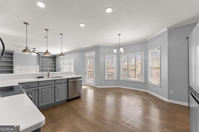 kitchen featuring dark wood-style floors, gray cabinetry, stainless steel dishwasher, ornamental molding, and a sink