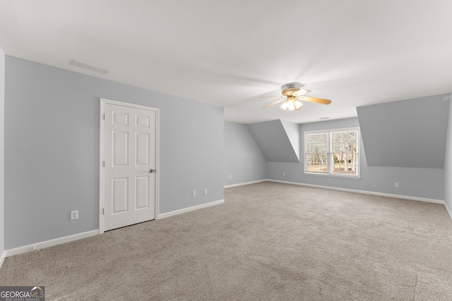 additional living space featuring visible vents, carpet flooring, a ceiling fan, and baseboards