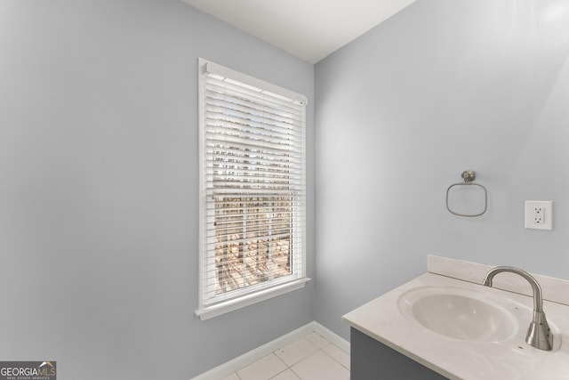 bathroom featuring tile patterned flooring, vanity, and baseboards