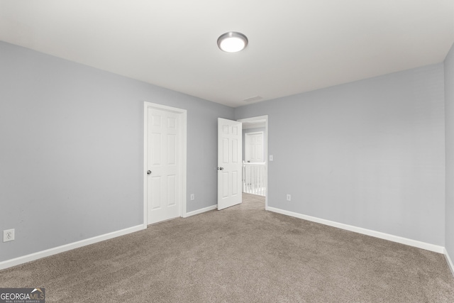 unfurnished bedroom featuring carpet flooring and baseboards