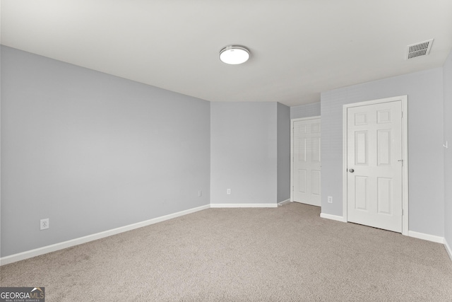 carpeted empty room with baseboards and visible vents