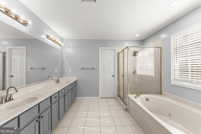 full bathroom featuring tile patterned flooring, a sink, and a shower stall