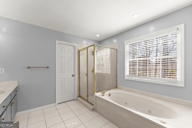 bathroom featuring tile patterned flooring, vanity, a shower stall, and a tub with jets