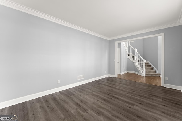 empty room with stairs, dark wood-style flooring, visible vents, and baseboards