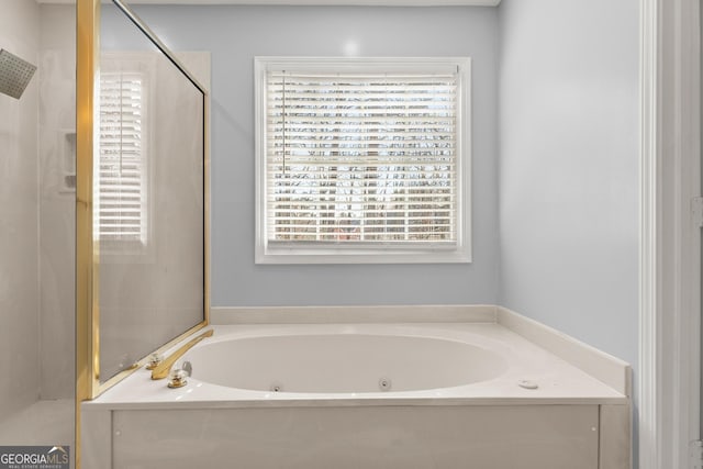 bathroom featuring a stall shower and a whirlpool tub