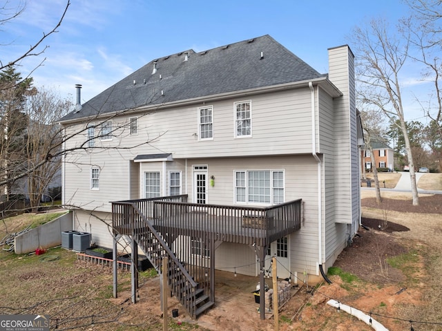 back of property featuring a shingled roof, a chimney, stairs, cooling unit, and a wooden deck