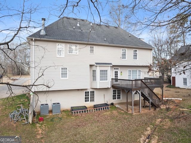 rear view of property with roof with shingles, stairs, cooling unit, and a wooden deck