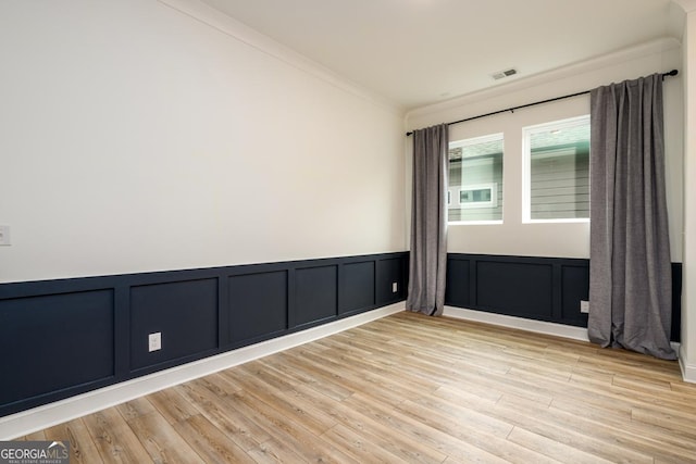 unfurnished room featuring crown molding and light hardwood / wood-style flooring