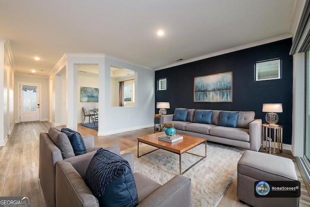 living room with ornamental molding and light hardwood / wood-style flooring