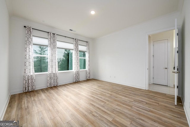 unfurnished room with crown molding and light hardwood / wood-style floors