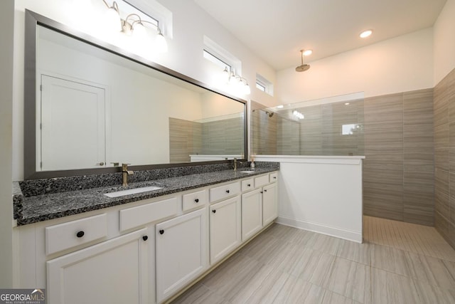 bathroom featuring vanity and a tile shower