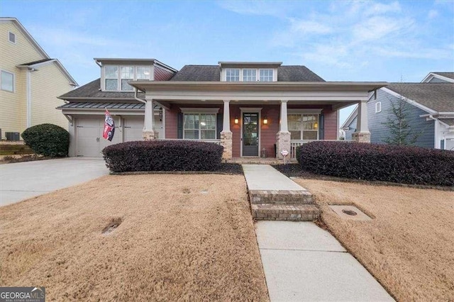 view of front of house featuring a garage and covered porch