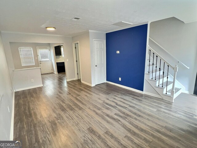 spare room featuring crown molding and dark hardwood / wood-style floors