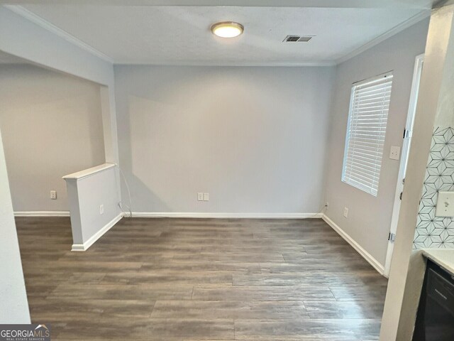 spare room with crown molding and dark hardwood / wood-style floors