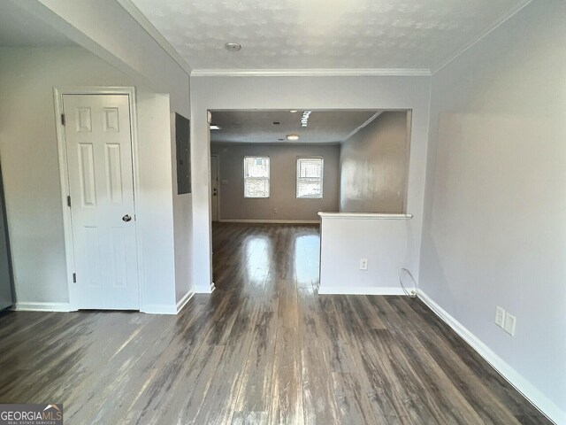 doorway to outside with ornamental molding and dark hardwood / wood-style floors