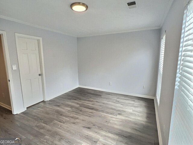 unfurnished bedroom with ornamental molding, a closet, and light hardwood / wood-style flooring