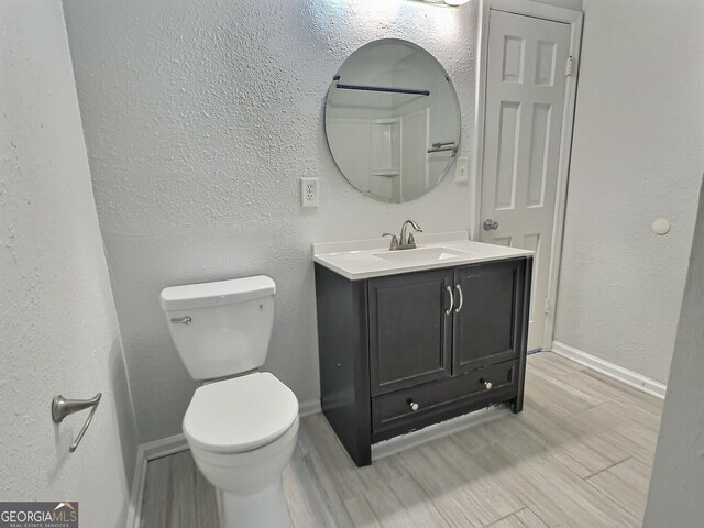 full bathroom with vanity, tub / shower combination, and toilet