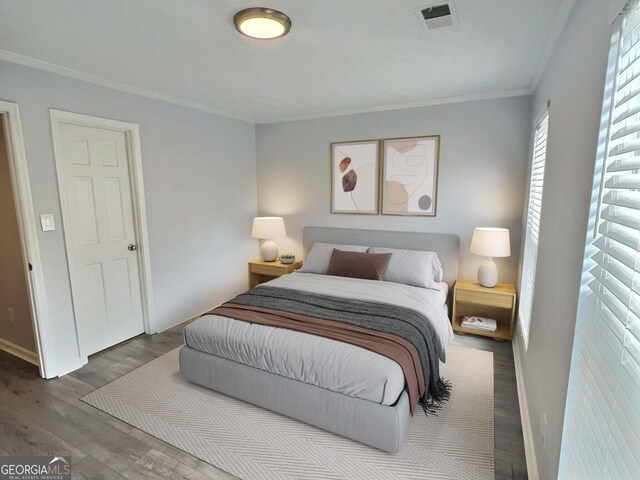 bedroom featuring a closet, ornamental molding, dark hardwood / wood-style floors, and a textured ceiling